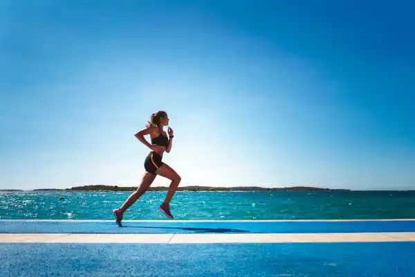 Woman running showing strong leg muscle Gosport